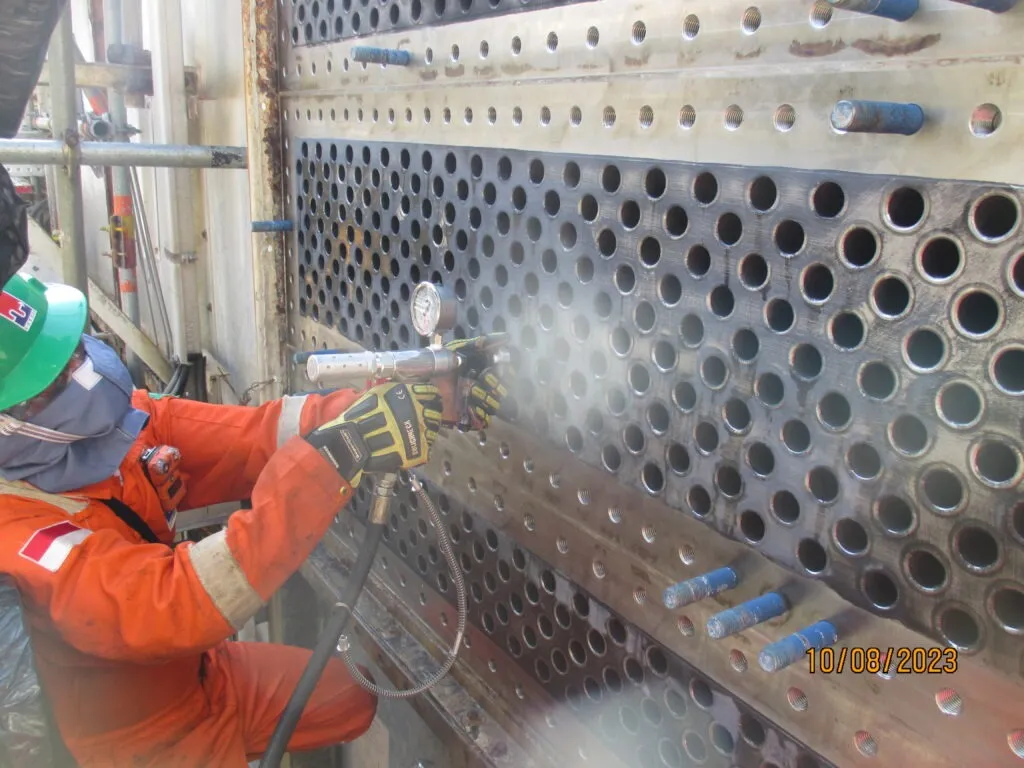 PT. HTSI technicians in safety gear servicing heat exchanger tubes